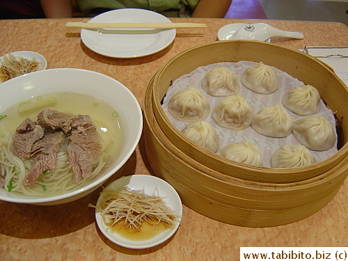 Famous Ding Tai Fung dumplings (right) and we mistakenly ordered boiled beef noodles (left)