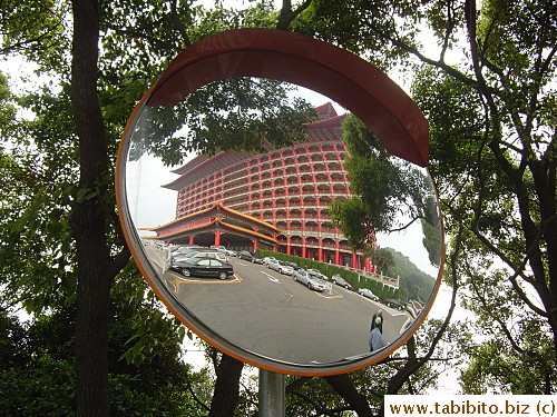 The Grand Hotel reflected on a street mirror