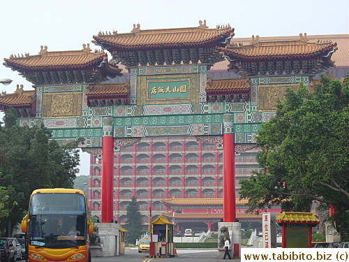 A large Chinese gate preceeds The Grand Hotel