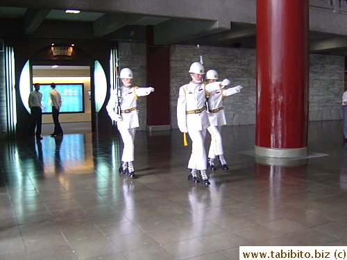 Every hour guards come out from behind the wall to replace the two standing guard of the statue