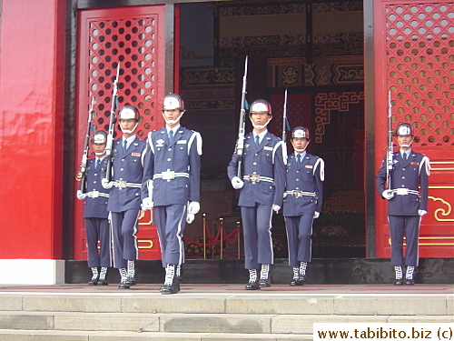 The two guards who have been in their post the last hour leave the shrine, their post replaced by two new guards