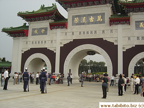 The guards walk back to the arch entrance