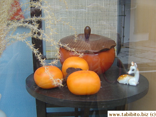 The shop window displays seasonal fruit