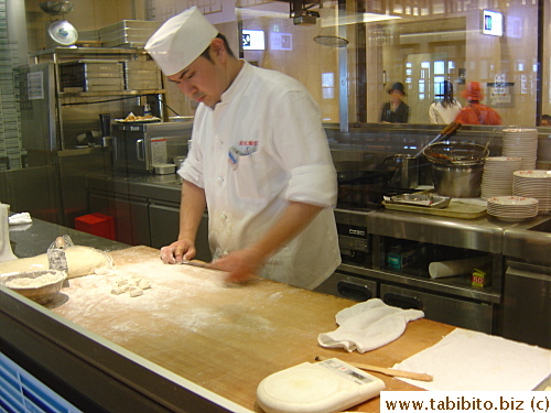 Chef in the glass encased open kitchen