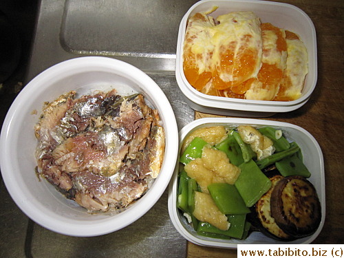 Canned spicy sardines, braised beans with fried tofu, sauteed eggplant, orange